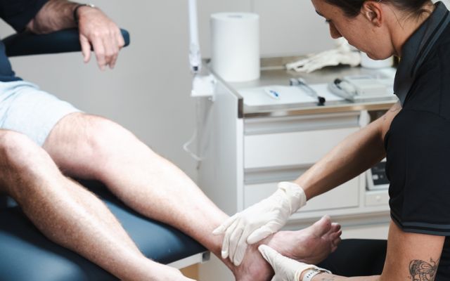 Podiatrist treating a patient's heel