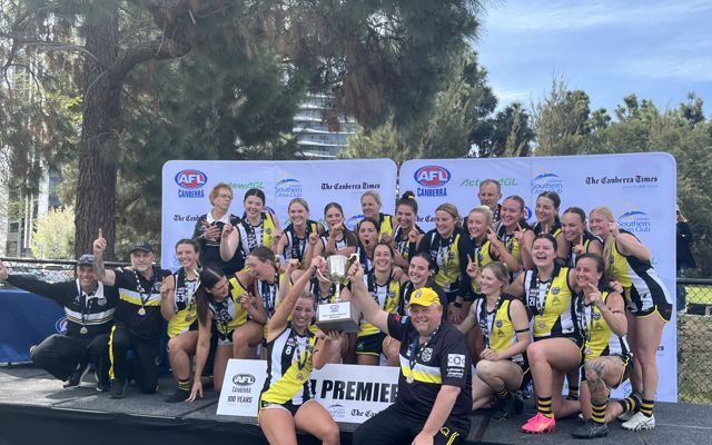 GB Podiatry and Sports polo with an AFL football